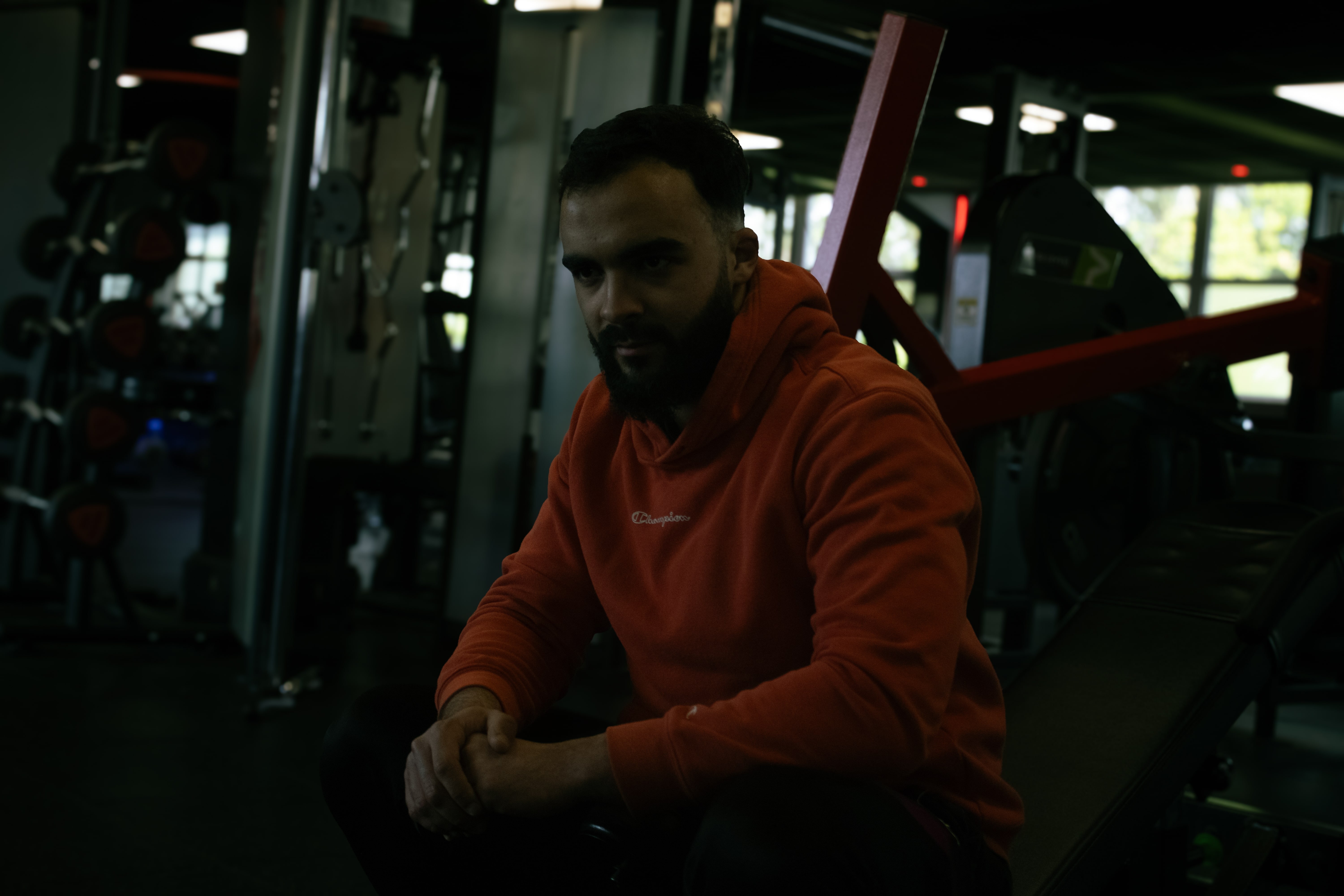 Man sitting on gym equipment
